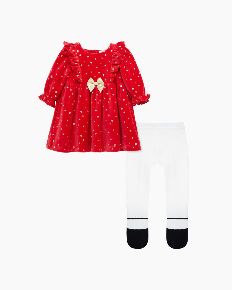 A red dress with white stars and a bow detail at the chest, accompanied by white tights with black Mary Jane shoes.